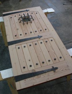 #61 Custom, handforged iron accents for a reclaimed wood door